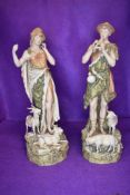 A pair of shepherd figures by Royal Dux having stamp to base one figure having slight damage