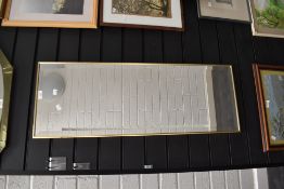 A long dressing mirror having bevel edged glass