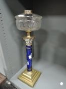 An elegant Victorian oil lamp having hand decorated Roman style column with ormolu decoration