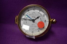 A brass porthole style quartz clock