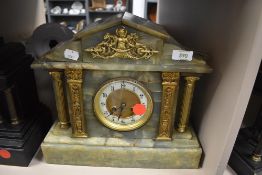 A marble mantel clock with green pillar design by W H Skinner of St Leonards on sea