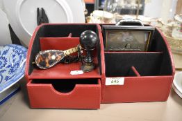 A modern desk top tidy with two Victorian photographs a tortoise shell miniature guitar and a set of