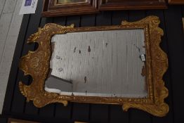 A Georgian mirror having Chippendale style carved gilt and gesso frame with silver backed mirror