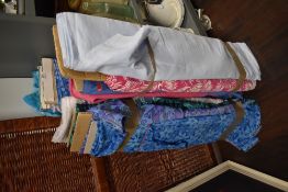 A selection of vintage and retro printed rolls of fabric and upholstery material