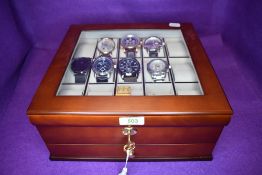 A 15 space watch box with lower drawer and lock containing eight gent's fashion wrist watches