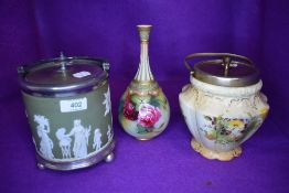 A biscuit barrel in a Jasper ware design with light green ground, a similar biscuit barrel and a