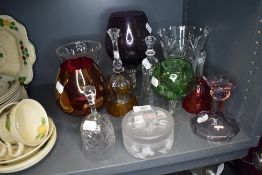 A selection of clear cut and colour art glass including large brandy or wine glass and bells