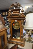 A German framed 8 day steeple clock with carved decoration