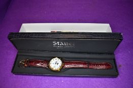 A gent's wrist watch by Stauer no:DS13373 having day, date, month and moon phase dials to face and