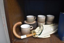 A vintage parasol or umbrella and a selection of Hornsea pottery tea cups and saucers