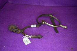Two horse riding spurs one traditional design and similar middle eastern or Islamic style
