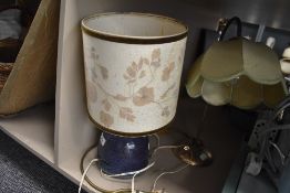 A ceramic studio pottery lamp base with flambe glaze and similar metal table lamp