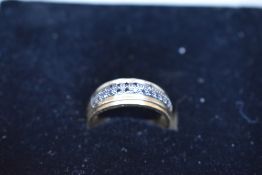 A 9ct gold band ring having a double row of black diamond chips, size W & approx 2.9g