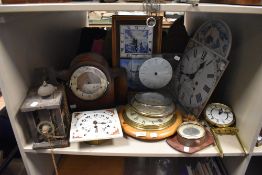 A shelf of clocks and parts (spares and repairs)