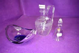 An art glass bowl with blue hue a water jug etched with holly leaf and a small bell