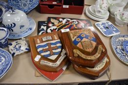 Five oak and hand painted crest shields and two similar hand painted motto crests