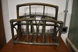 A bamboo framed magazine or similar storage rack