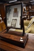 A 19th Century toilet mirror on plain base with turned feet, width approx. 45cm