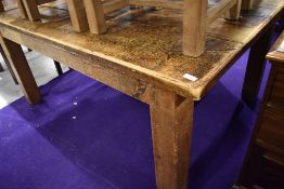 A large rustic kitchen table having grooved (simulated plank) top, on chunky square legs , approx.