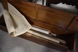 A vintage wooden box containing a selection of ordnance survey or similar plans including marine