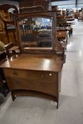 An Arts and Crafts oak dressing table having copper handles, width approx. 99cm