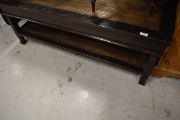 An Oriental style coffee table having bamboo centre and undertier, approx. 120 x 68cm
