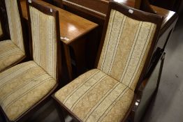 A vintage G plan gateleg dining table and four similar upholstered dining chairs