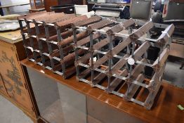 A pair of metal wine racks, labelled Farrow and Jackson , Millom
