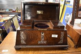 A 19th Century mhogany tea caddy of sarcophagus form with mother of pearl inlay and fitted interior