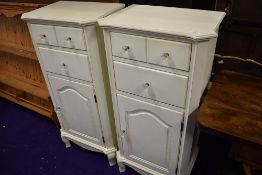 A pair of modern laminate bedside cabinets with drawer and cupboard storage