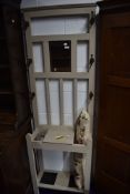 An Edwardian hallway cloak or coat stand having mirror back