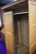 A craftsman made golden oak wardrobe, attributed to Peter Hall of Staveley, width approx. 122cm