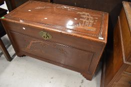 An Oriental bedding box having carved decoration depicting bamboo and prunus blossom, dimensions