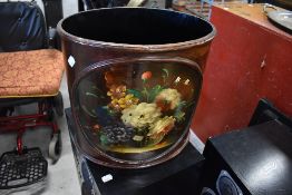 A stained waste paper bin with painted panel