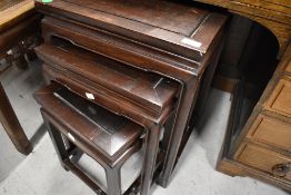 An Oriental hardwood nest of three tables