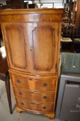 A modern yew wood cocktail cabinet having double cupboard and internal light