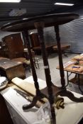 A late 19th/early 20th Century circular occasional table, on four turned columns and splay legs,