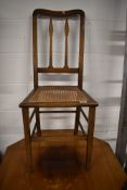 A bedroom chair having oak frame with woven seat
