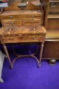A regency style ladies parlour desk having flame veneer fold out desk on tapered legs