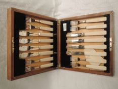 A 1930's cased eight place set of silver fish knives and forks having ivory handles, Sheffield 1937,