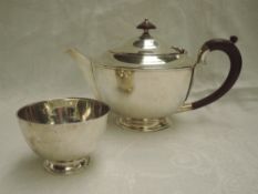 A silver tea pot and sugar bowl of plain form having fruit wood handle and knop, London 1937,