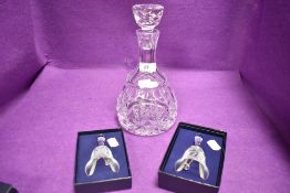 Two Caithness Christmas bells having etched designs with box and a glass wine decanter