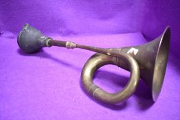 A vintage motor car bulb horn having brass body