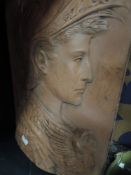 A large Italian influenced terracotta wall plaque depicting a Romanesque mythical warrior AF