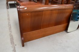A modern hardwood bedstead, sleigh style, width approx. 6ft