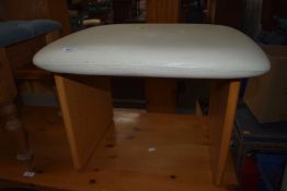 An oak effect and vinyl topped seat