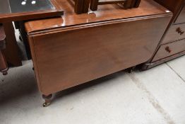 A late C19th/early C20th drop leaf dining table on turned legs, approx w 106cm