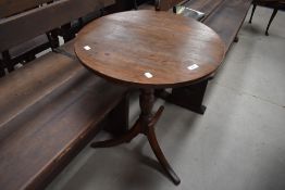A 19th Century oak pedestal occasional table having turned column and triple splay legs, diameter