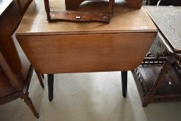 A reproduction drop leaf dining table having splay legs