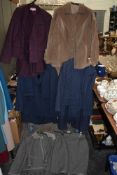 A collection of ladies retro skirt suits and jackets, different colours and styles.